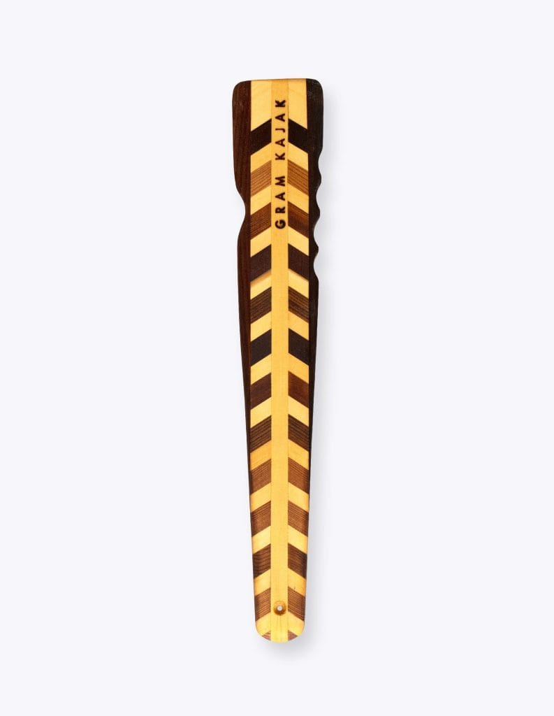 Gram 6110 norsaq throwing stick laminated in a chevron pattern of dark and light wood, with finger grooves