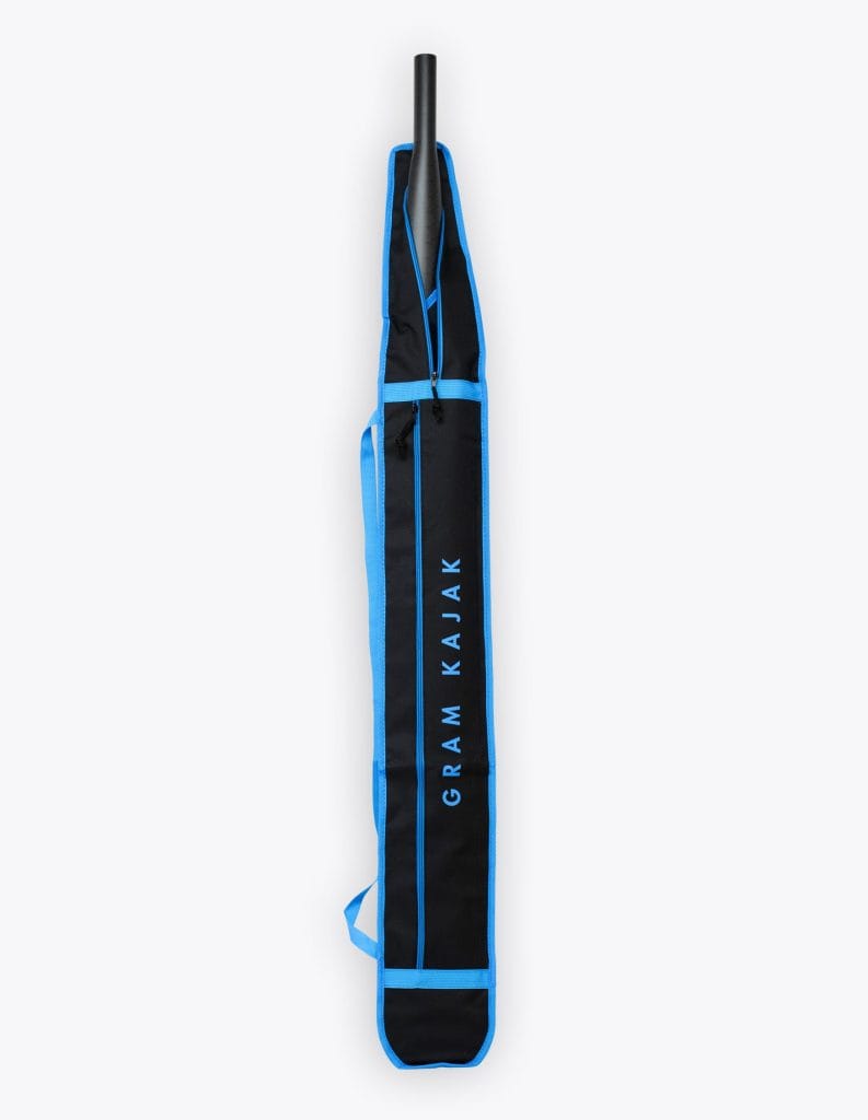 Short black Gram paddle bag with blue trim for split paddles, carbon paddle shaft showing at the top