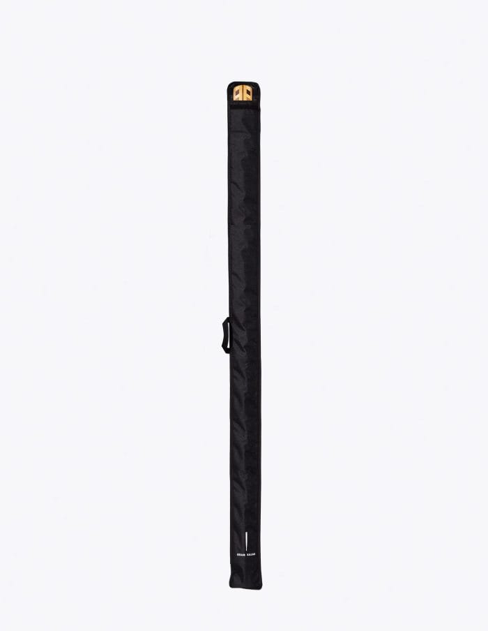 Black full-length Gram paddle bag for a one-piece Greenland paddle, with a wooden paddle at the opening