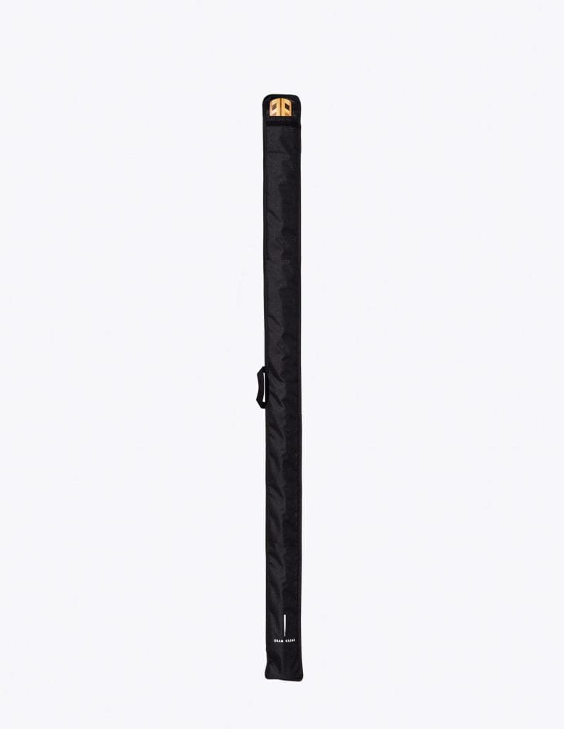 Black full-length Gram paddle bag for a one-piece Greenland paddle, with a wooden paddle at the opening